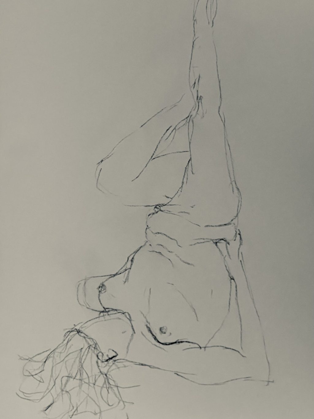 Pencil drawing of a female resting on the ground with her legs in the air. One leg bent forwards